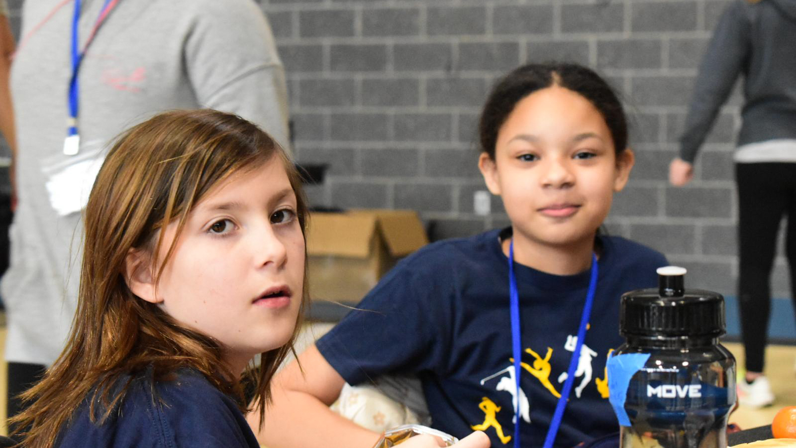 Two young girls smiling.