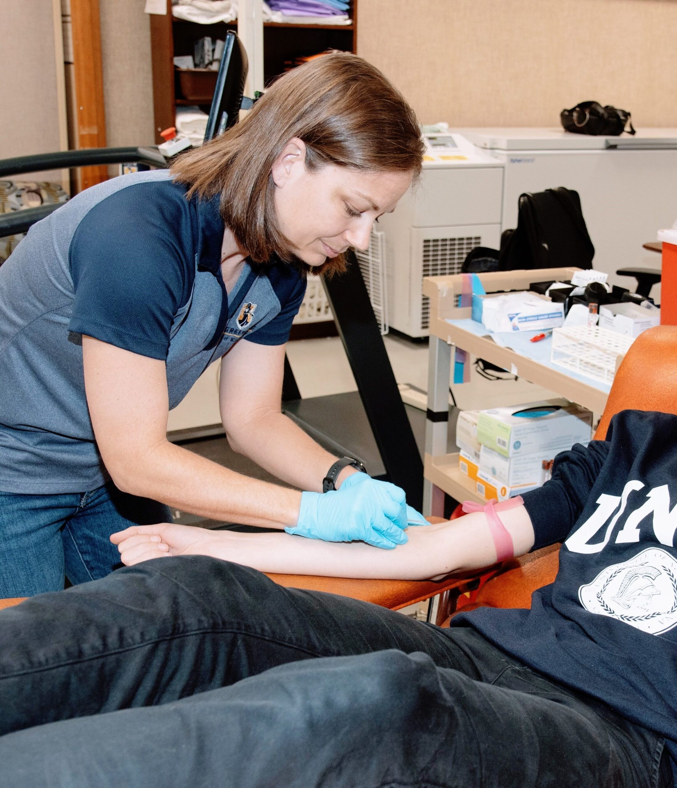 Sam draws blood from participant for lab study