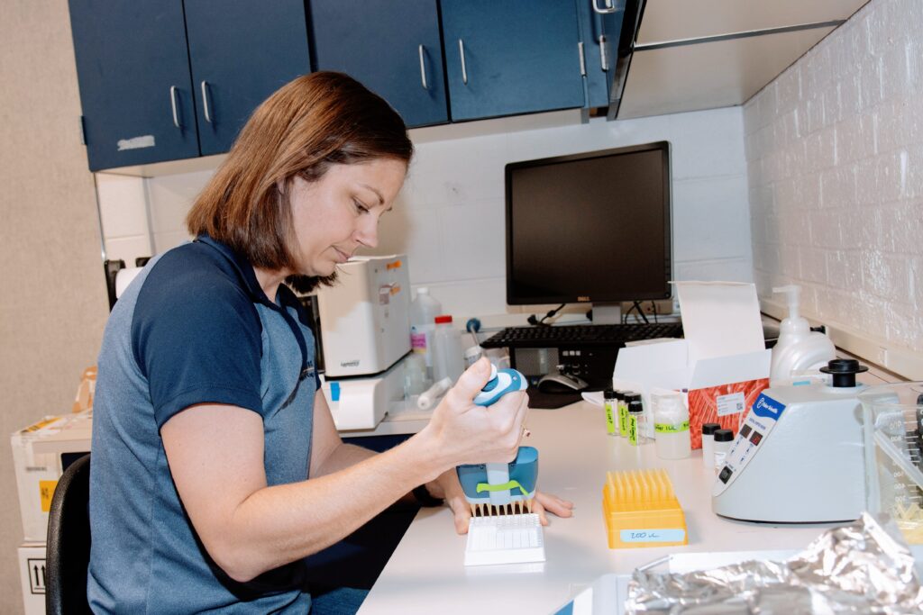 Woman with brown hair does lab work