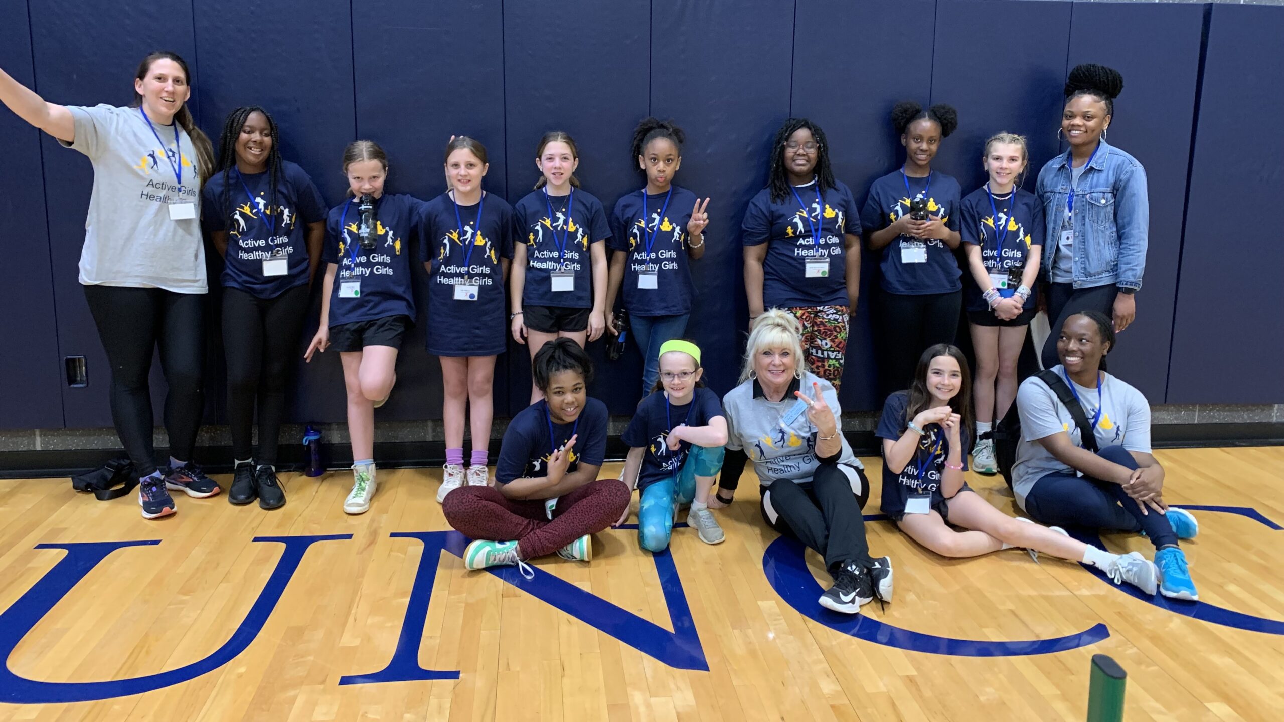 Active Avengers campers pose with camp counselors and pickle ball instructor standing side by side