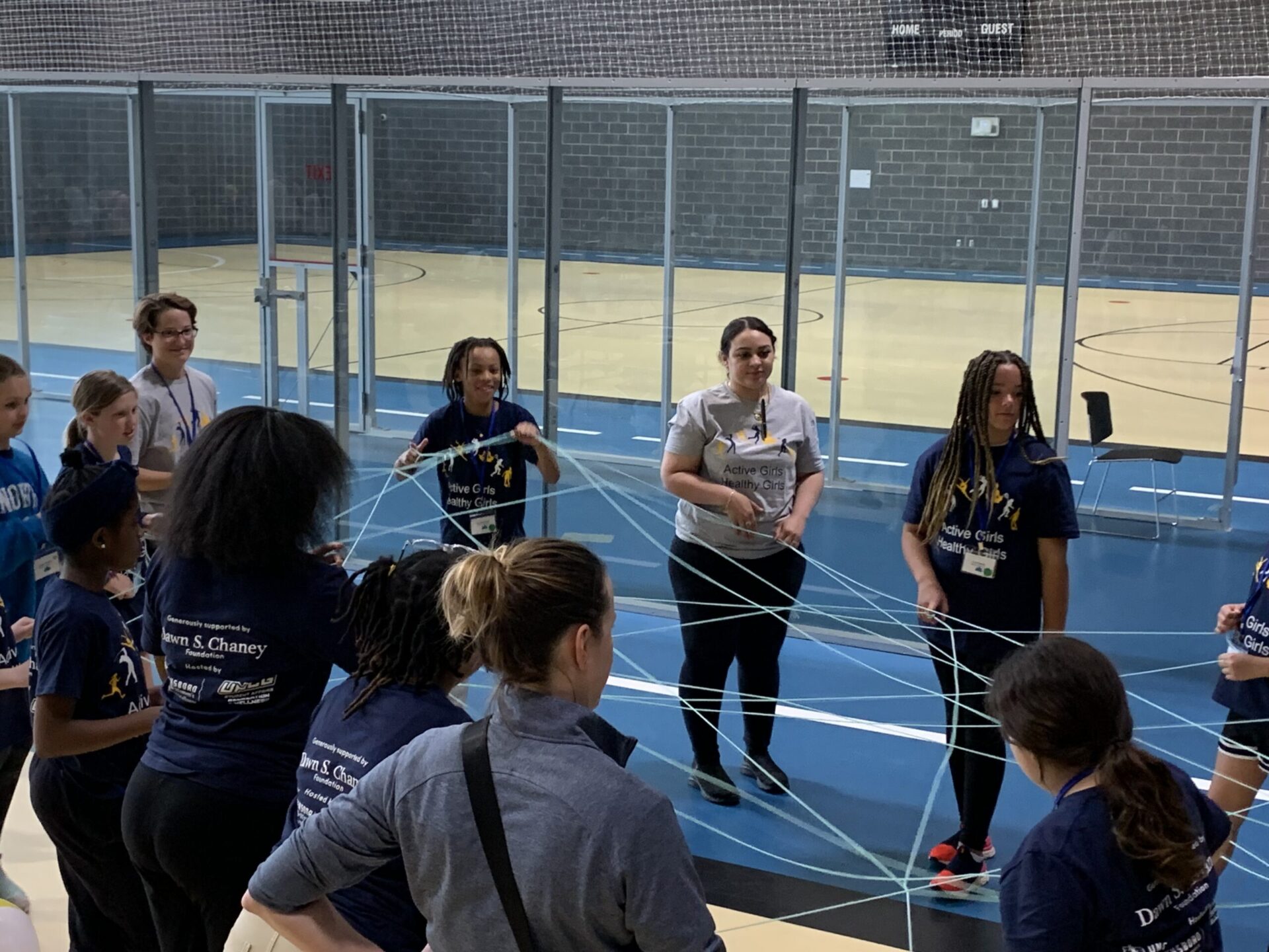 Web of support activity with girls holding yarn creating a web