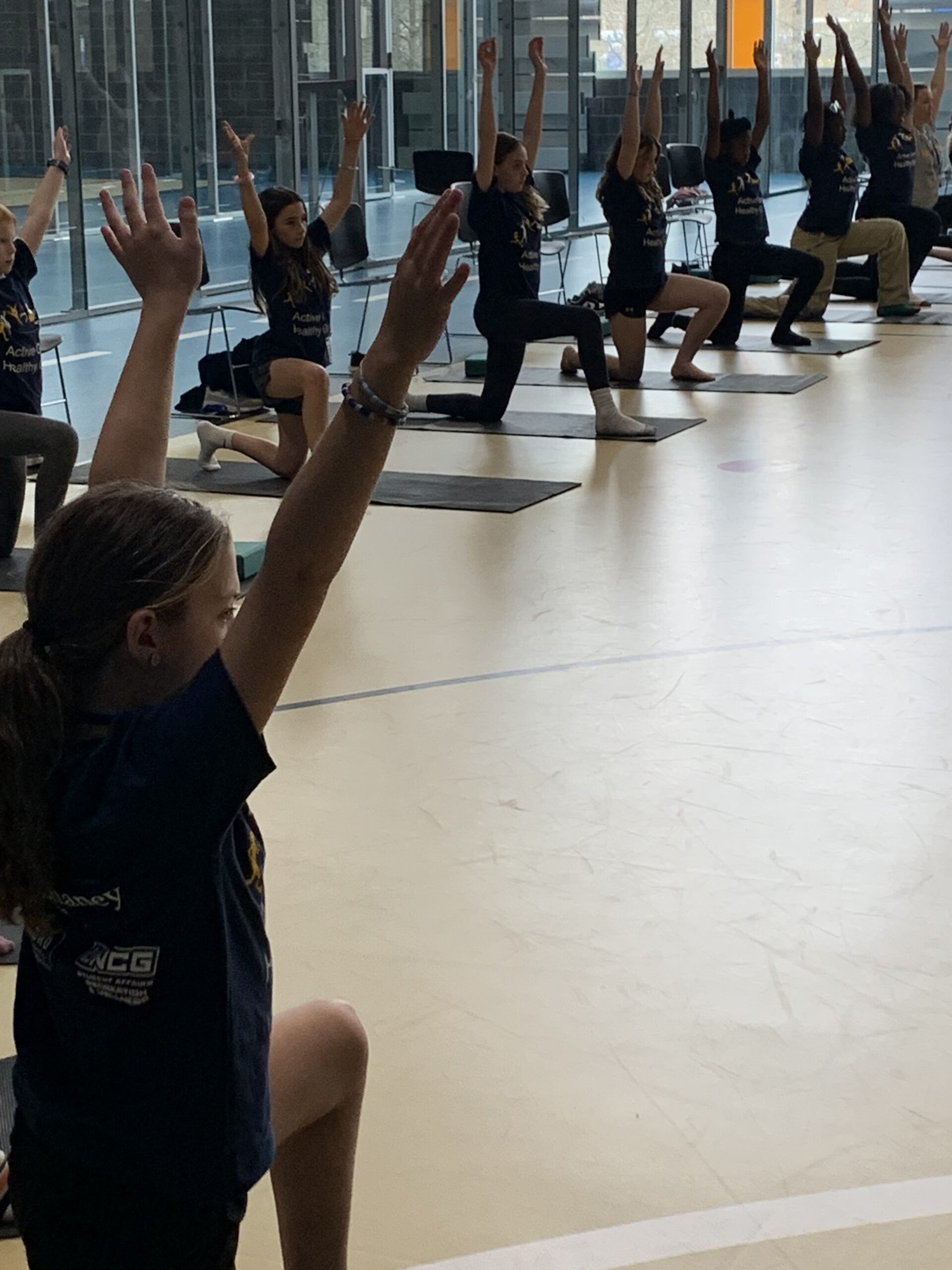 Campers doing yoga warrior pose