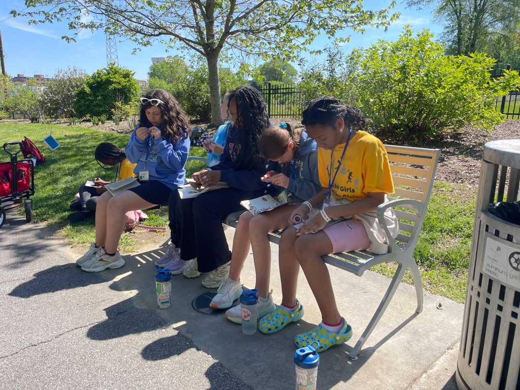 AGHG campers and counselor engaged in the nature journaling session.